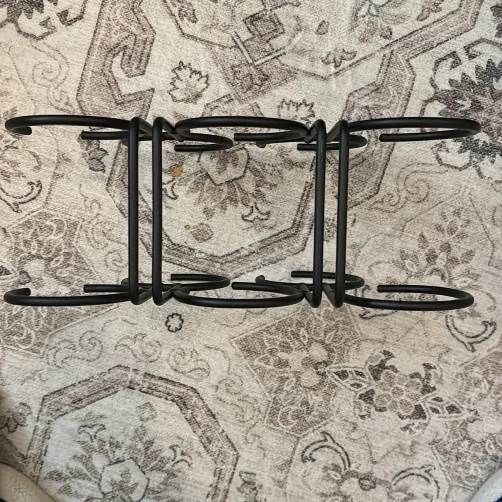 Gently used black metal wine holder